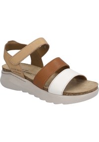 Strappy sandals featuring tan, brown, and white leather bands, a cushioned footbed, and a lightweight white sole with textured accents.