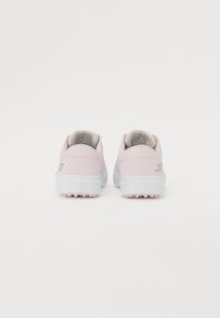 Light pink athletic shoes with a smooth synthetic upper, white outsole, and grey accents. Textured sole with small grip patterns.