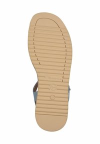 Light blue sandal with a textured insole and thin straps, featuring a ridged tan rubber sole and a circular logo imprint.