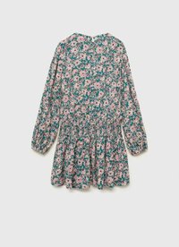 Kukkaistakki, jossa on teal-tausta, jossa on vaaleanpunaisia ja valkoisia kukkia, pitkät puffi-hihat ja kootut vyötärö. Takana avaus avaimen muodossa.