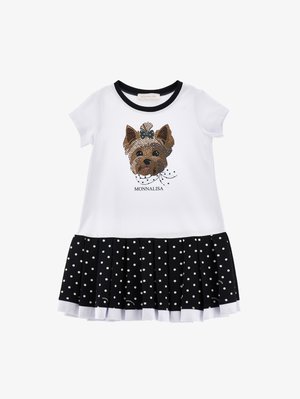 Biała sukienka z krótkim rękawem, czarnym kołnierzem, nadrukiem psiej twarzy z kokardą, napisem "MONNALISA" oraz czarną plisowaną spódnicą w białe kropki.