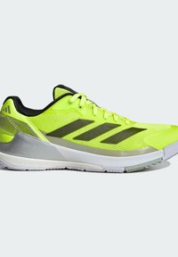 Neon yellow athletic shoe with black accents, synthetic upper, and a cushioned sole. Features three black stripes and textured design.