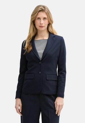 Navy blazer with two front pockets and a single button closure, layered over a striped shirt. Smooth texture, tailored fit, professional design.