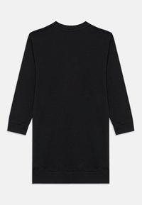 Svart langermet kjole laget av mykt stoff. Har rund hals og rett kant nederst med ribbede mansjetter. Enkel design, uten mønstre.