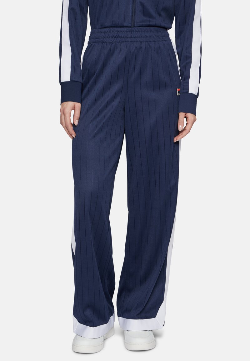 Pantaloni da jogging navy a righe con pannelli laterali bianchi, vita elastica e polsini affusolati. Realizzati in tessuto morbido e leggero.