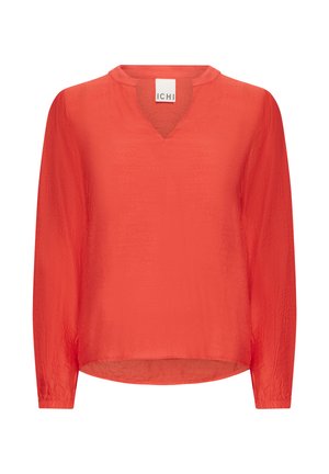 Blouse rouge à manches longues avec un col en V, faite d'un tissu léger et légèrement texturé, présentant une coupe décontractée et un ourlet arrondi.