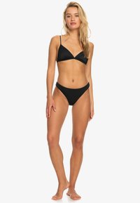 Čierny bikini set obsahujúci textúrovaný trojuholníkový vrch s tenkými popruhmi a vysokým pásom. Jednoduchý dizajn s jednofarebným prevedením a minimálnym kovovým doplnkom.