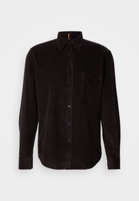Dark brown corduroy shirt with a button front, point collar, long sleeves, single chest pocket, and textured ridged pattern.