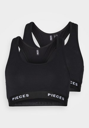 Black sports bras, made of soft fabric, featuring a racerback design and a contrasting band with "PIECES" logo at the hem. Two-pack.
