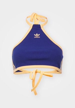 Crop top Adidas bleu et jaune à encolure licou avec logo au centre devant et fermetures à nouer au niveau du cou et du dos.