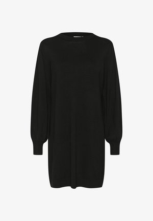 Must mustriga mustriga kleit, mis on valmistatud pehmest kudumaterjalist. Omab ümarat kaelust, puffi varrukate ja veidi lõdva istuvust.