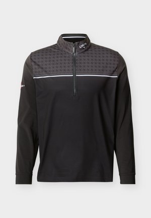 Pullover da golf nero a maniche lunghe con spalline a fantasia, striscia bianca sul petto, mezza cerniera frontale e logo Callaway su colletto e manica.