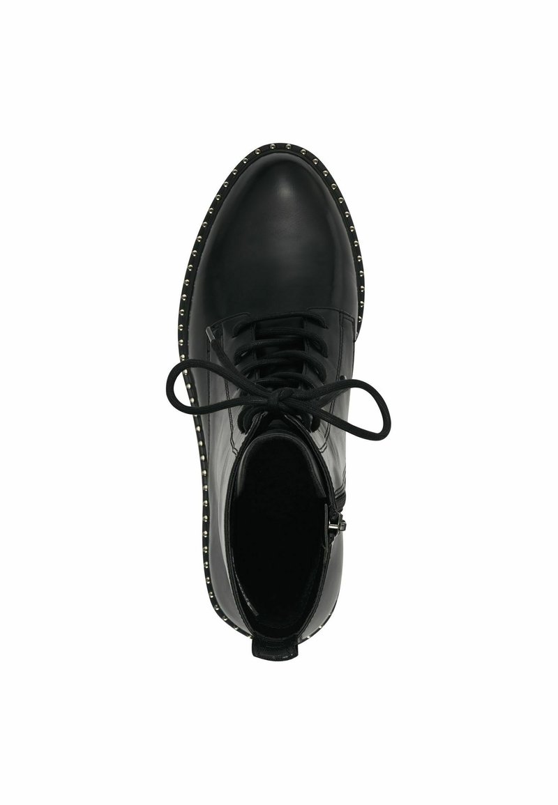 Chaussures en cuir noir avec un bout arrondi, un laçage et de petites clous le long de la semelle. Texture lisse avec une finition mate.