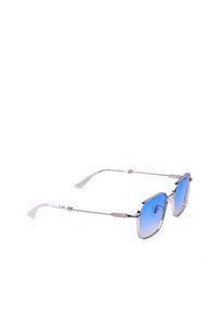 Lunettes de soleil carrées avec verres à dégradé bleu, fines montures métalliques argentées et embouts de branches texturés transparents sur fond blanc.