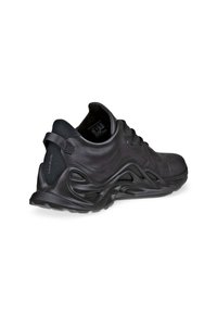 Black athletic shoe with a textured synthetic upper, curved design, padded collar, and a thick, flexible sole with wavy patterns.