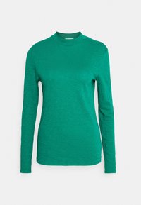 Maglietta a maniche lunghe di un verde vivace, con un collo alto e un tessuto leggermente testurizzato. Design semplice, silhouette aderente.