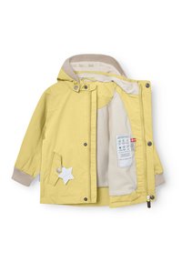 Rumena otroška jopica z rjuho s kapuco v bež barvi, manšetami z rebrastim vzorcem, sprednjim žepom ter zapiranjem z gumbi na pritisk in zadrgo.