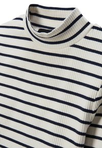 Pull à col roulé côtelé en crème avec des rayures horizontales navy. Il présente une coupe ajustée et une texture douce, idéal pour le superposition.