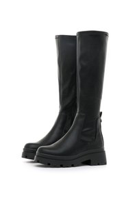 Botas negras hasta la rodilla hechas de cuero suave, con cremallera lateral, suela gruesa con relieves y diseño de punta redonda.