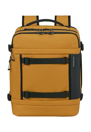 Square mustard yellow backpack with black straps, handles, front buckles, and a Samsonite logo on the side panel.