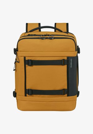 Square mustard yellow backpack with black straps, handles, front buckles, and a Samsonite logo on the side panel.
