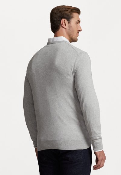 Light gray sweater made of soft fabric, featuring a simple design, long sleeves, and ribbed cuffs, viewed from the back.