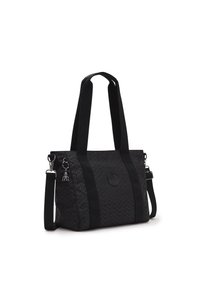 Sort tote taske med geometrisk mønster, stofmateriale, dobbelte håndtag, aftagelig skulderrem og en lille dekorativ charme.