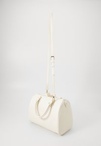 White faux leather handbag with rounded shape, dual top handles, adjustable shoulder strap, gold hardware accents, and textured surface.