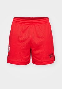 Red mesh basketball shorts with an elastic waistband, featuring a black logo and text detail on the side, designed for breathability.