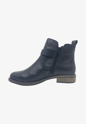 Botte de cheville en cuir noir avec fermeture éclair, détails cousus autour de la semelle et un petit talon empilé. Texture lisse avec une forme structurée.