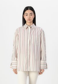 Collared button-up shirt in lightweight fabric, featuring vertical stripes in red, blue, and cream. Includes a chest pocket and wide sleeves.
