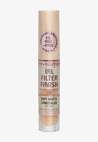 Correcteur mat doux dans un tube cylindrique transparent. Couleur pêche clair avec une étiquette dorée et rose. Présente des revendications d'étanchéité à l'eau et sans huile.