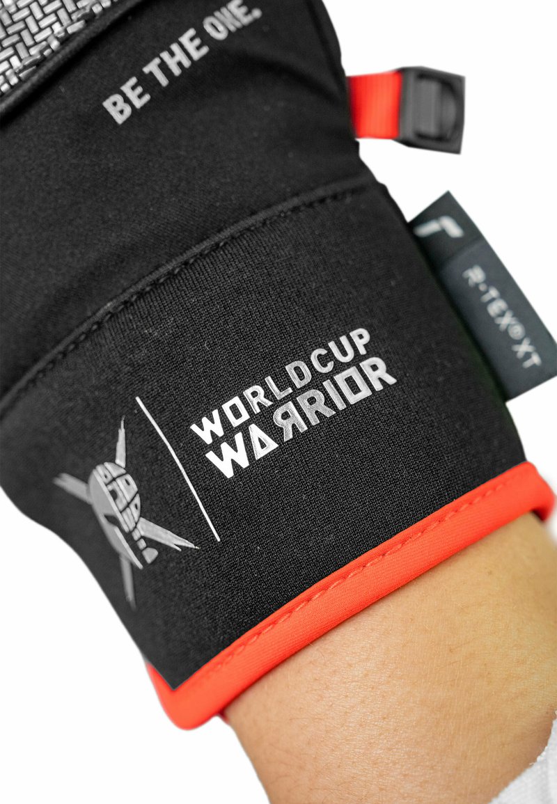 Schwarze Sporthandschuhe mit roten Akzenten, strukturiertem Oberflächen und bedruckten Logos "BE THE ONE" und "WORLD CUP WARRIOR". Robustes Material.