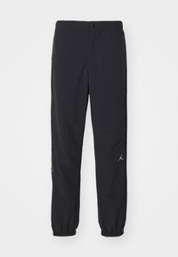 Black track pants made of lightweight fabric, featuring an elastic waistband, tapered cuffs, and a small logo on the left leg.