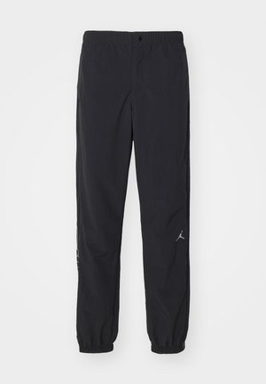 Black track pants made of lightweight fabric, featuring an elastic waistband, tapered cuffs, and a small logo on the left leg.