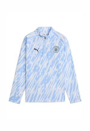 Pull bleu clair à manches longues avec col zippé à moitié. Présente un motif de rayures diagonales et le logo de Manchester City sur la poitrine.
