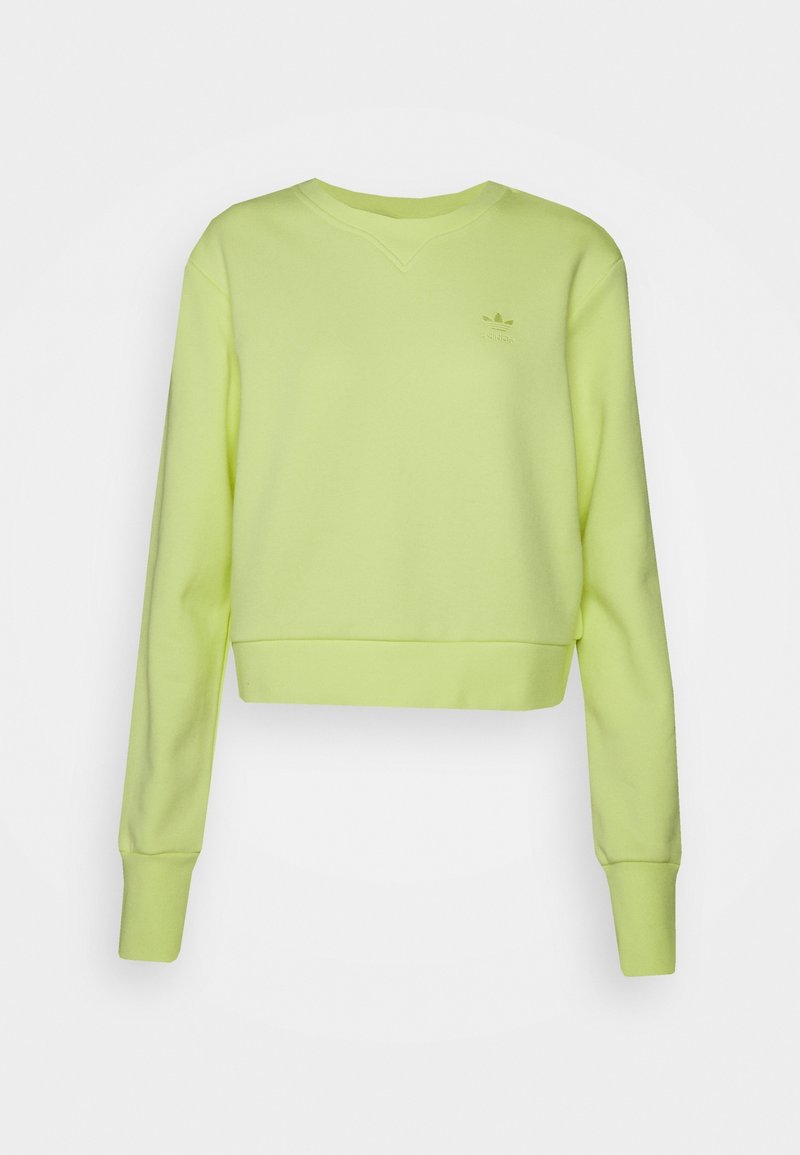 Sweatshirt vert clair cropped avec des manches longues et des poignets côtelés, arborant un petit logo Adidas sur le haut à gauche de la poitrine.