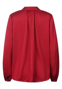 Rote Bluse mit langen Ärmeln, aus glattem Stoff gefertigt. Verfügt über einen klassischen Kragen, Falten im Rücken und elastische Bündchen.