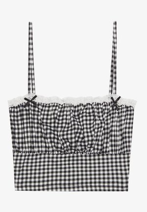 Bralette in materiale gingham bianco e nero con bordo in pizzo, design arricciato e sottili spalline regolabili con piccole fiocchetti sulla parte anteriore.