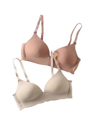 Two smooth, lightly padded bras with adjustable straps, one beige and one light brown, displayed on a white background.