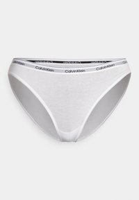 Slip in cotone bianco di Calvin Klein con elastico in vita nero. Design semplice che presenta una texture liscia e una forma classica di bikini.