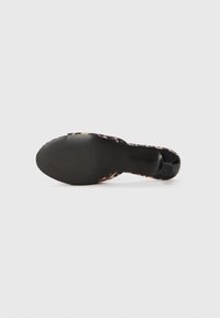 Black platform shoe with a leopard print upper, smooth texture, rounded toe, and a ridged rubber sole.