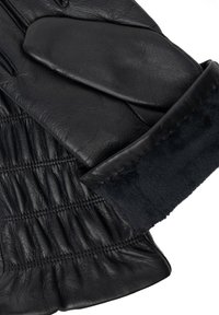 Sorte læderhandsker med en blød shearling manchet, der har en samlet tekstur og glat finish på fingrene. Holdbart og varmt design.