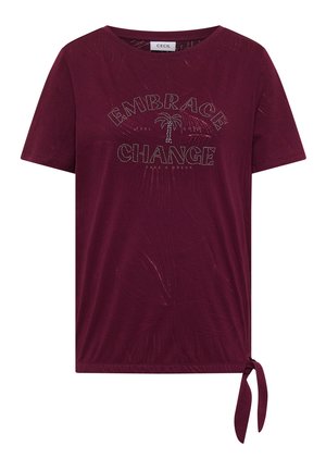 T-shirt bordeaux à manches courtes avec un motif de palmier, le texte « Embrace Change », un motif discret de feuilles et un détail de nœud sur le côté à l’ourlet.