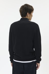 Pulover negru tricotat cu textură tip rebrodare, având un guler înalt și mâneci lungi, prezentat din spate pe un fundal simplu.