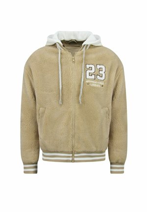 Beige fleece zip-up hoodie met witte capuchon en koorden, geribde manchetten en zoom met witte strepen, en nummer 23 patch op de borst.