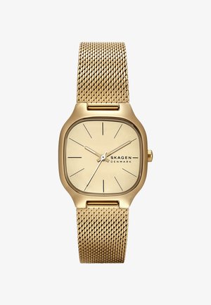 Reloj de pulsera de malla dorada con caja cuadrada, esfera dorada clara, indicadores de horas delgados y un diseño minimalista. Nombre de la marca "SKAGEN" destacado.