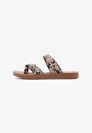 Open-toe sandals with black and gold snake-print straps, featuring two adjustable buckles and a tan rubber sole with a textured finish.