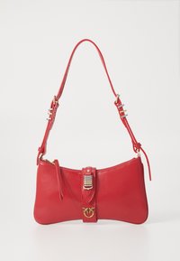 Red leather handbag with a flat, bow-shaped design. Features a gold clasp and adjustable strap with silver accents. Zipper closure at the top.