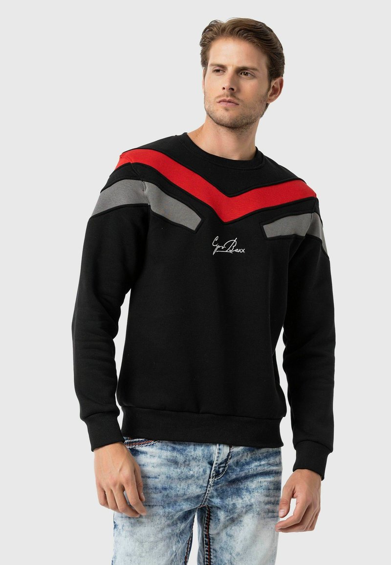 Zwarte sweatshirt met rode en grijze chevronstrepen op de schouders, geribbelde manchetten en zoom, met geborduurd logo op de voorkant.